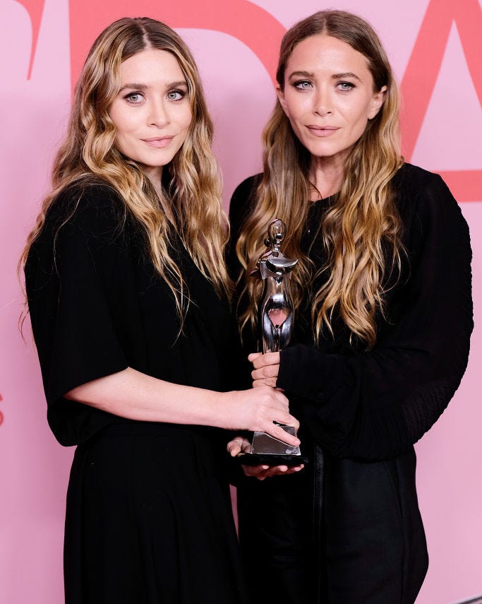 Ashley and Mary-Kate Olsen are among the world's richest actors ashley and mary kate olsen holding a trophy from an award show