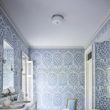a blue and white bathroom with a large soaking tub