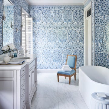 a blue and white bathroom with a large soaking tub