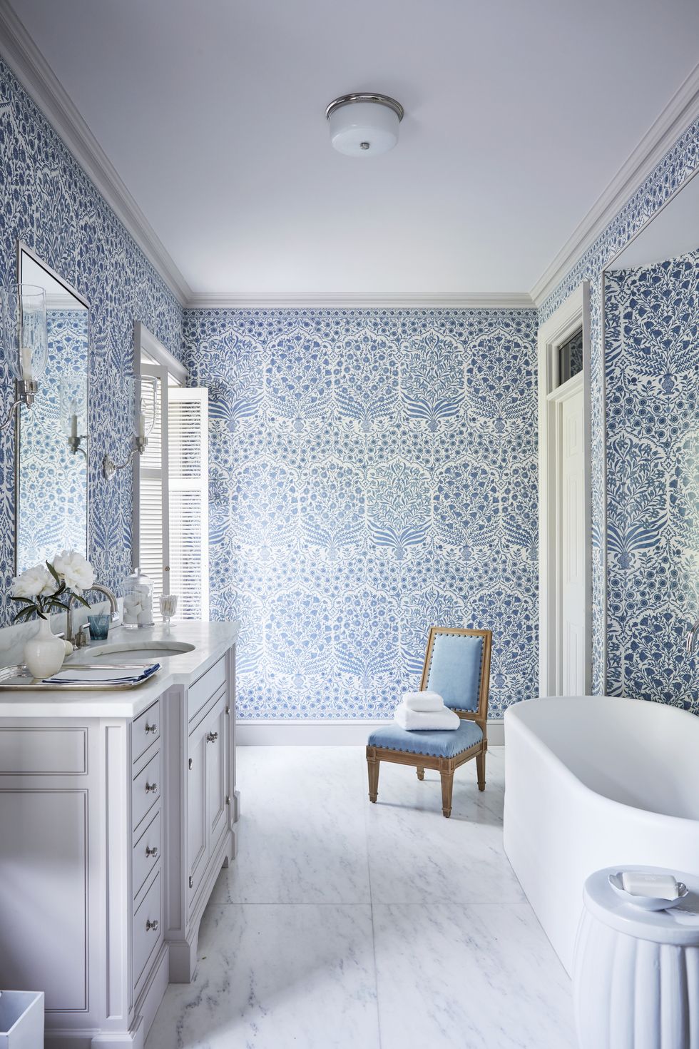a blue and white bathroom with a large soaking tub