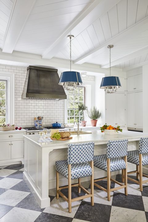 in a kitchen a duo of disarming patterns enlivens warm shades of white in counters and cabinetry and subway tile