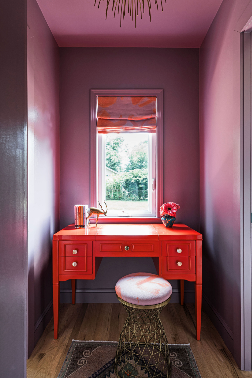 office with lilac walls and red desk
