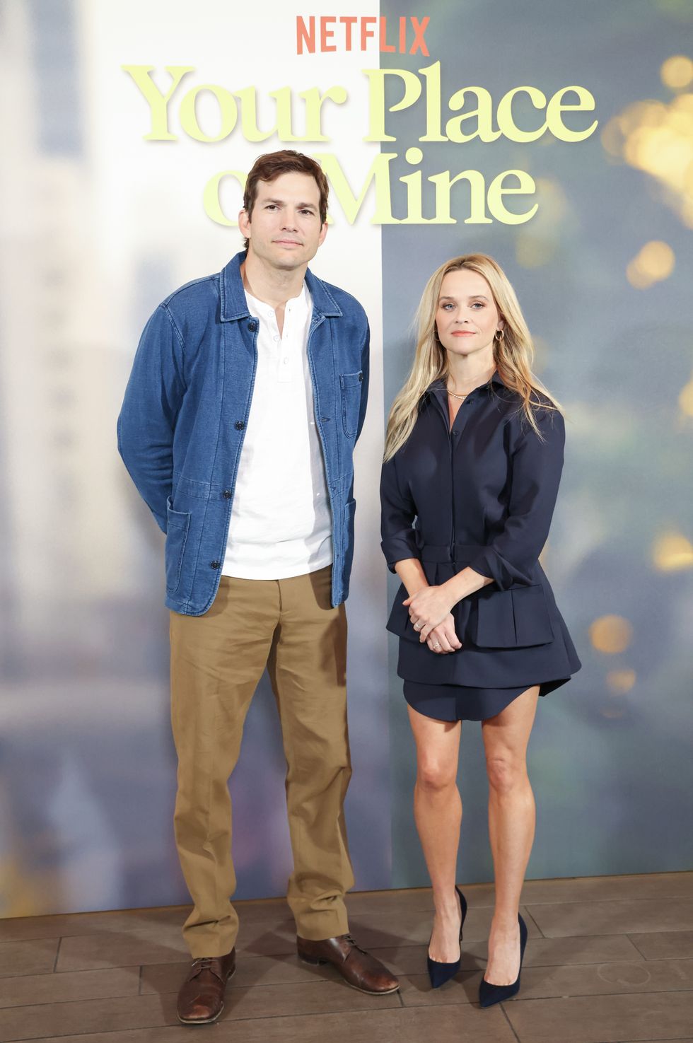 ashton kutcher and reese witherspoon at the photocall for netflix's "your place or mine"