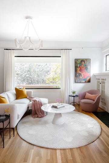 living room with modern decor featuring a sofa armchair coffee table and artwork
