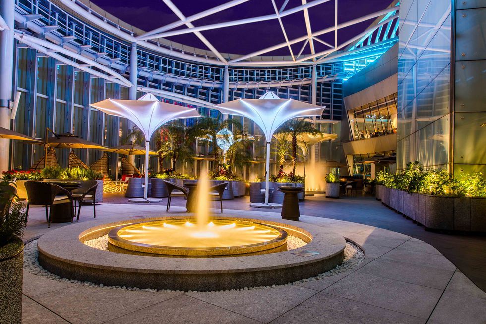 Fountain, Building, Lobby, Lighting, Sky, Architecture, Water feature, Night, Tree, Real estate, 