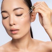 best retinol creams  asian beautiful female is applying eye serum
