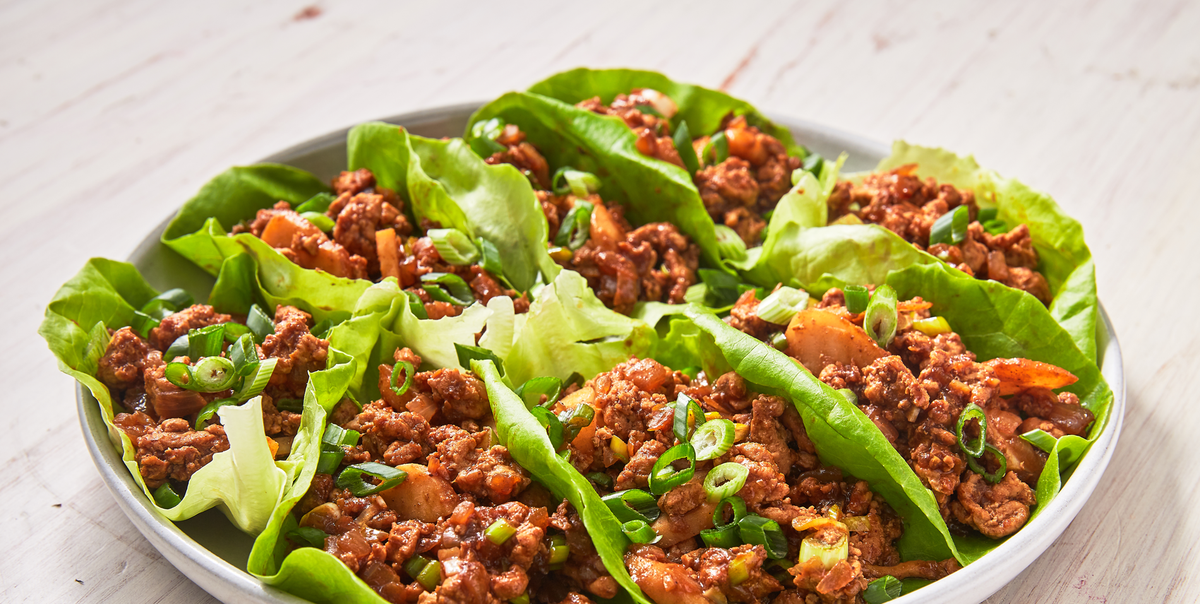 asian ground chicken lettuce wraps on a white plate