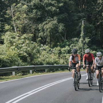 asian chinese female cyclist leading in rural cycling event