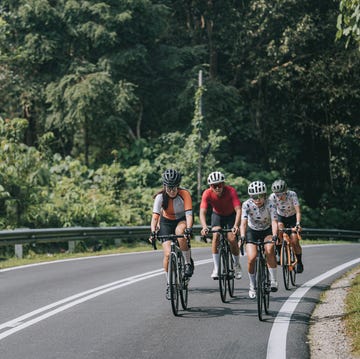 asian chinese female cyclist leading in rural cycling event