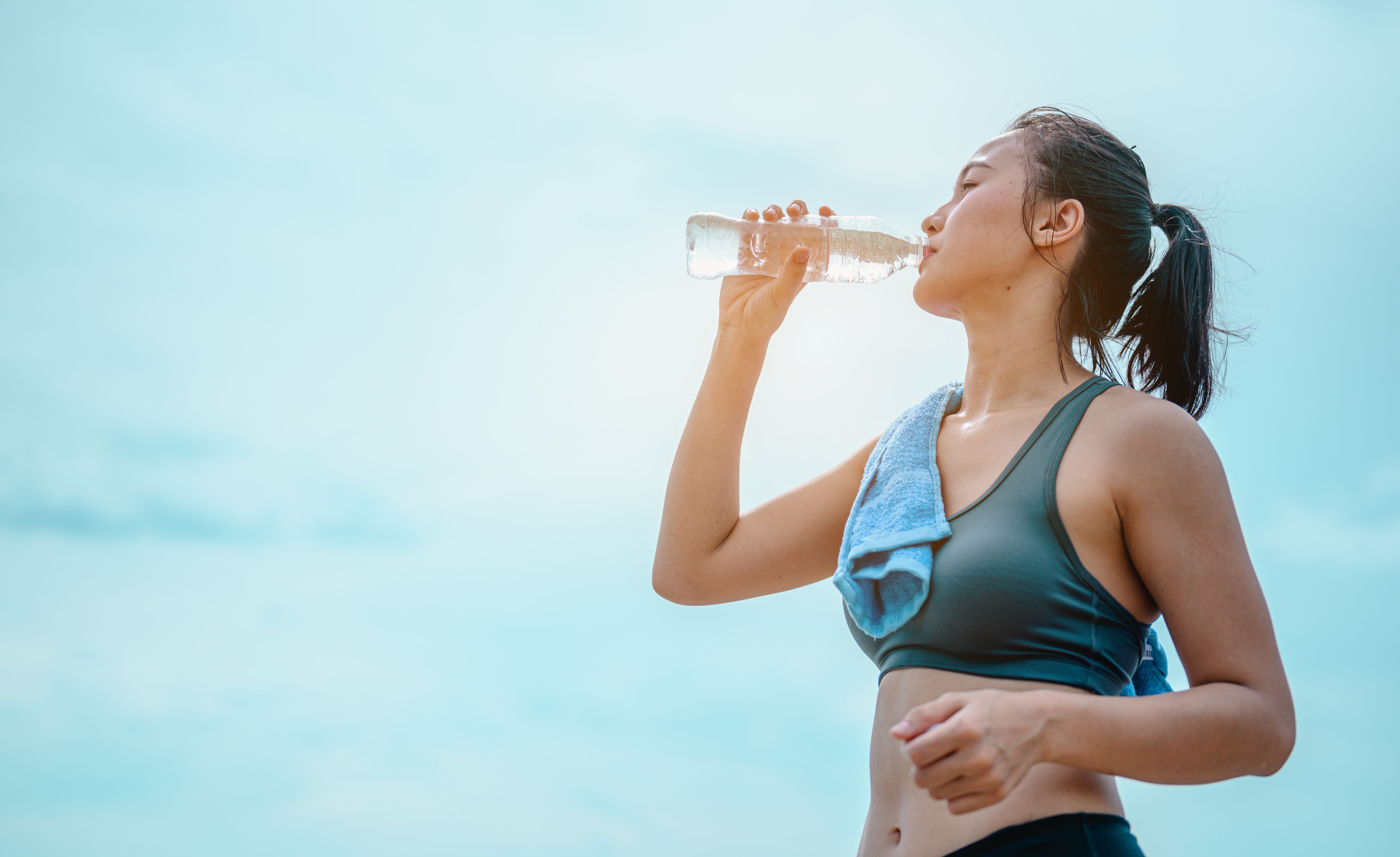https://hips.hearstapps.com/hmg-prod/images/asian-female-jogger-drinking-fresh-water-after-royalty-free-image-1688130742.jpg