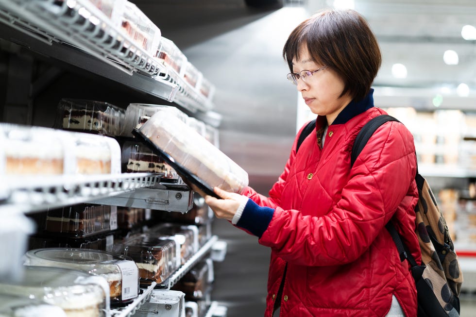 asian female shopping in supermarket