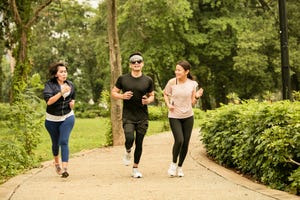 asian group adult running in the gelora bung karno park, jakarta, indonesia