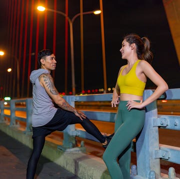 Asian man and woman exercising in the city at night. asian man and woman exercising in the city at night