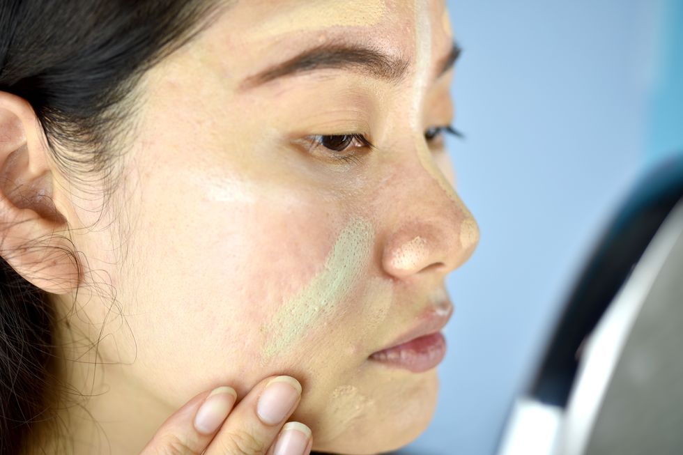 Asian woman applying cosmetics makeup and using color correction concealer, Face skin preparing before makeup foundation, Learning doing self makeup.