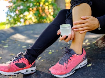 asian woman applying cream after exercise