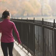 asian woman running on waterfront path