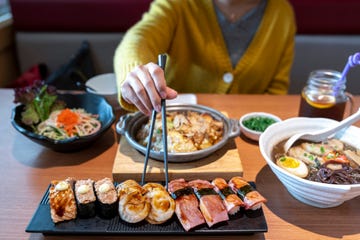 asian woman tasting japanese food in the restaurant