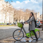 asian woman using ebicycle in the city