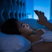 Asian women are using the smart phone on the bed before she sleeping at night. Mobile addict concept. Asian women are using the smart phone on the bed before she sleeping at night. Mobile addict concept.