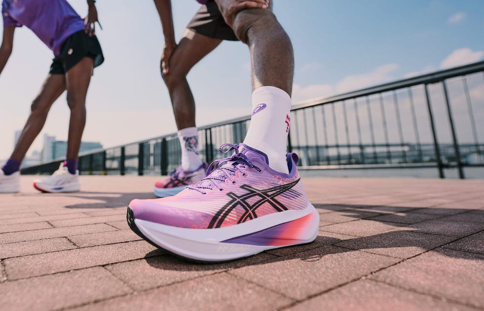 a person wearing a cushioned purple running shoe
