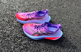 a pair of purple cushioned running shoes
