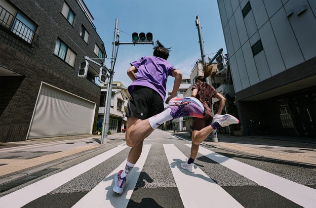 two people running down a street