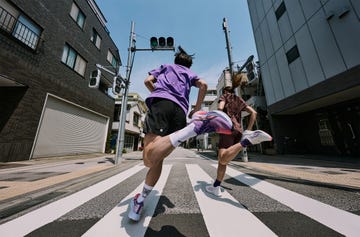 two people running down a street