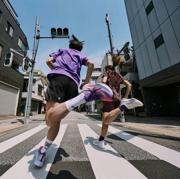 two people running down a street two people running down a street