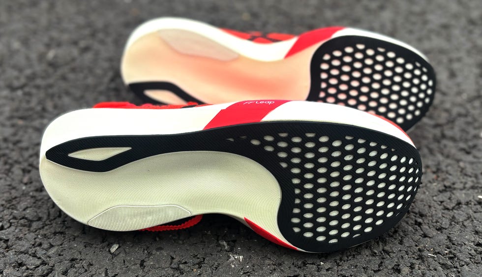 a pair of black and red running shoes on their side
