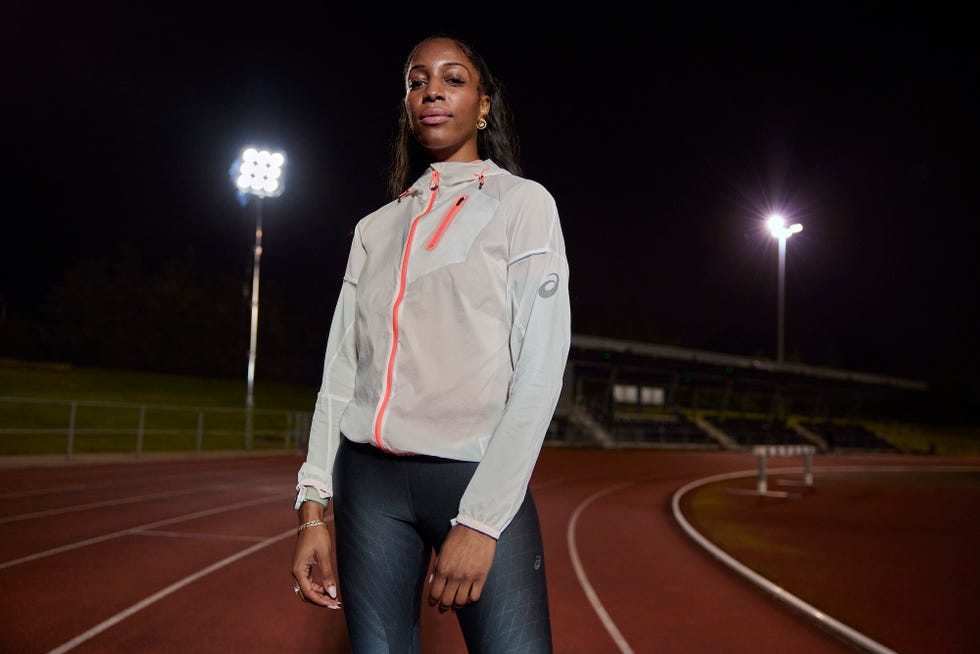 a woman standing on a track at night