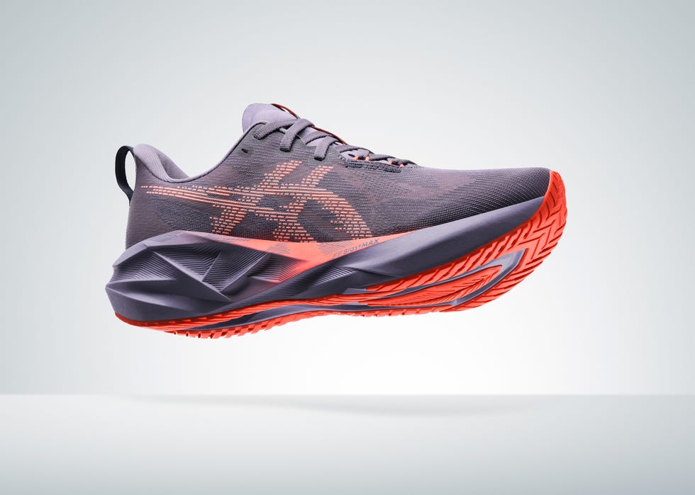 a modern athletic shoe featuring a predominantly gray upper with a patterned design it includes striking red accents on the sole and midsole, showcasing a dynamic and sporty aesthetic