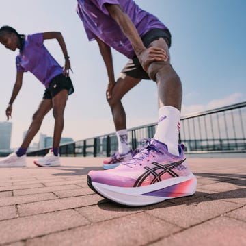 two athletes stretching in athletic wear on a sunny outdoor track two athletes stretching in athletic wear on a sunny outdoor track