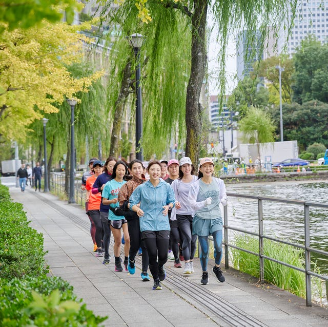 a group of people posing for a photo on a bridge