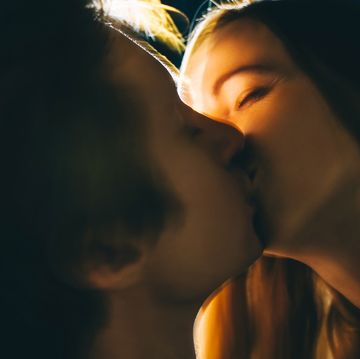 young couple in love in dark with back lit close up
