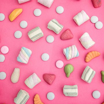 asorment of candies and sweets in pink background