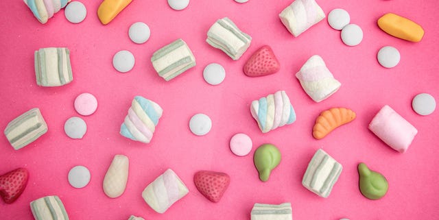 asorment of candies and sweets in pink background