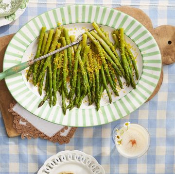 a plate of steamed asparagus with salt cured egg yolks on a platter