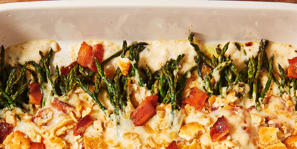 cheesy asparagus casserole topped with bacon and crushed ritz crackers
