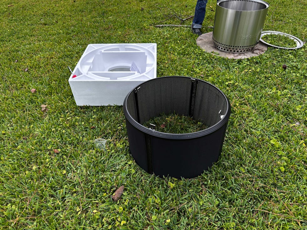 solo stove in a back yard with a screen on it