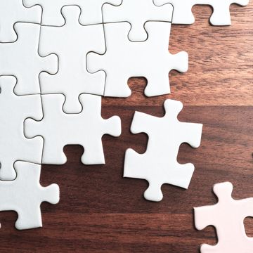 assembling jigsaw puzzle pieces abstract background