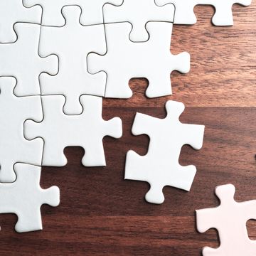 assembling jigsaw puzzle pieces abstract background