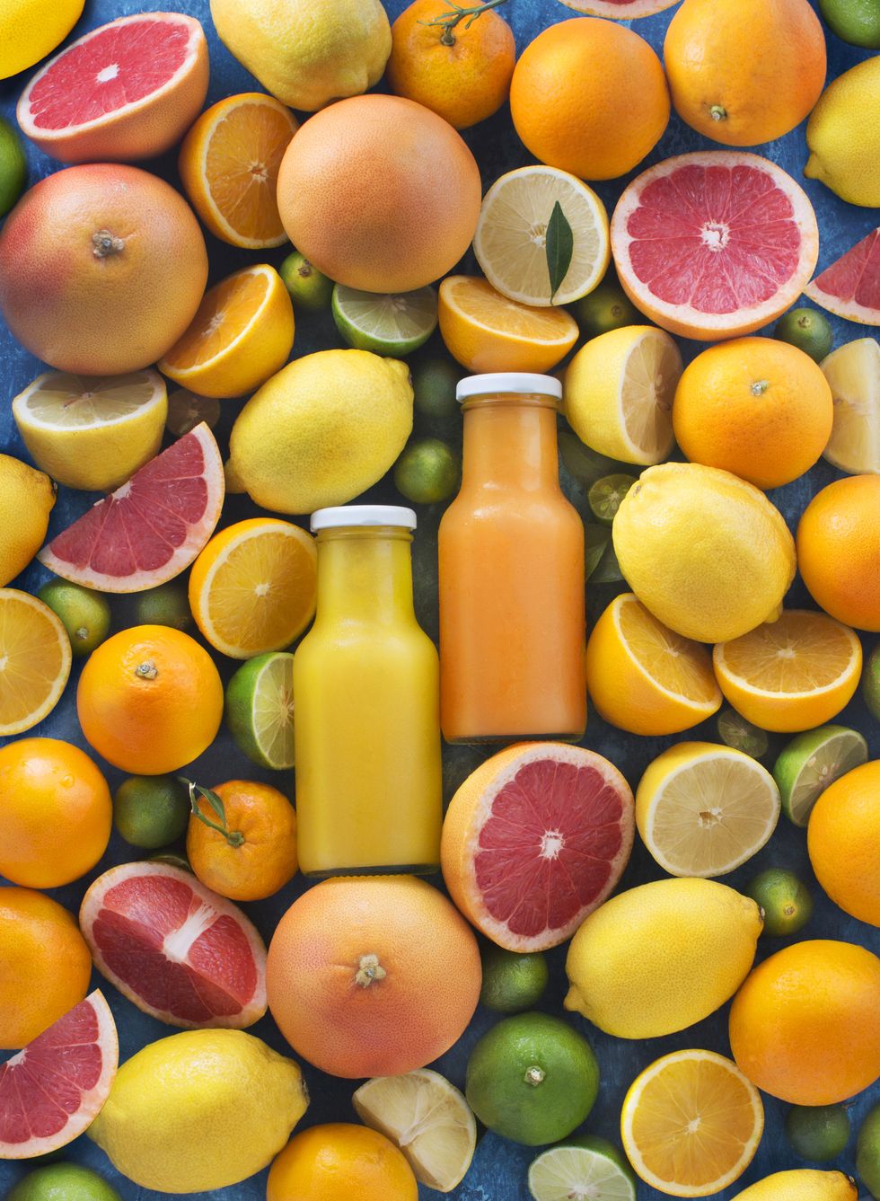 assorted citrus fruits and juice in bottles