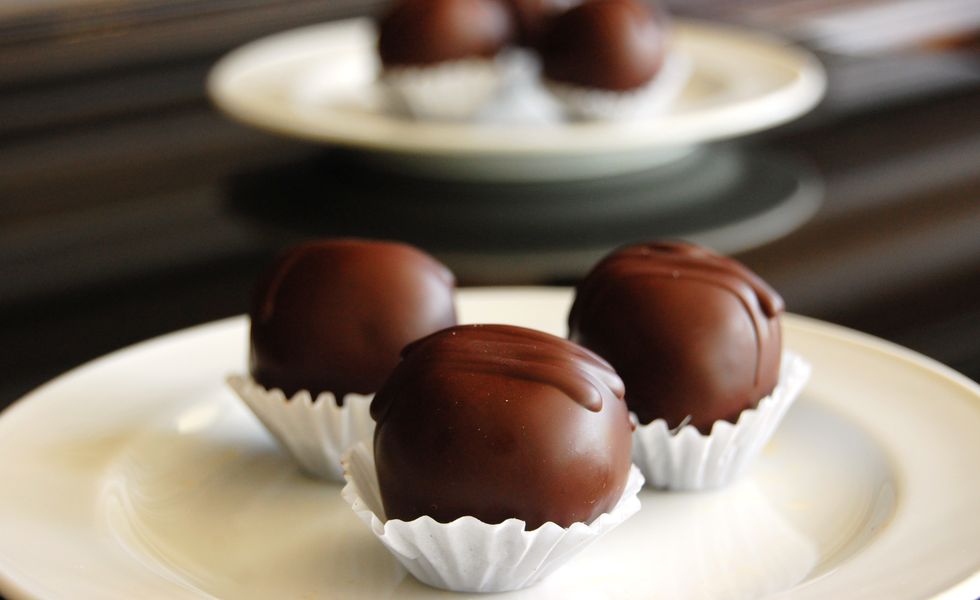 Assorted dark chocolate truffles with cocoa powder,