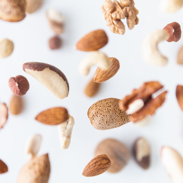 assorted nuts flying above white background, levitation effect