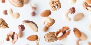 assorted nuts flying above white background, levitation effect