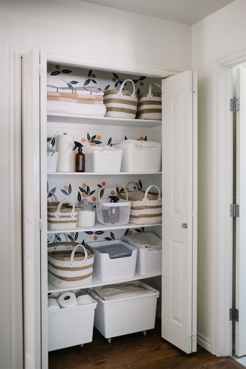 linen closet organization with an assortment of storage containers