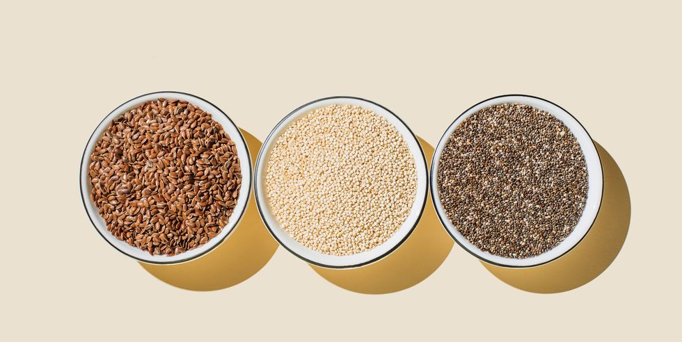 assortment of seeds, healthy food ingredients, superfood flat lay, top view, copy space chia, flax seeds, white sesame seeds on beige background