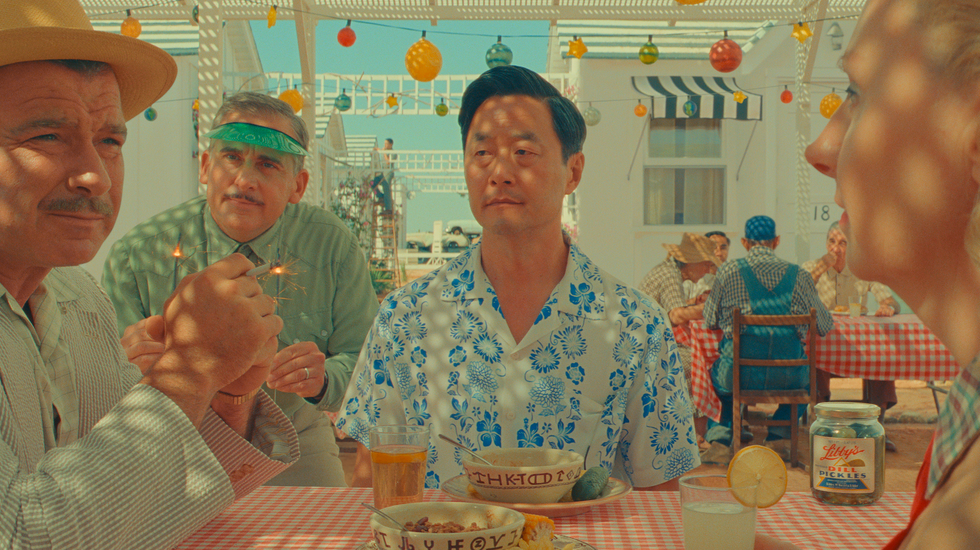 liev schreiber as jj kellogg, steve carell as motel manager, stephen park as roger cho, and hope davis as sandy borden in wes anderson's asteroid city