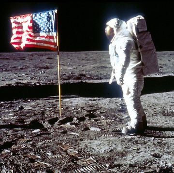 buzz aldrin poses next to the us flag on moon