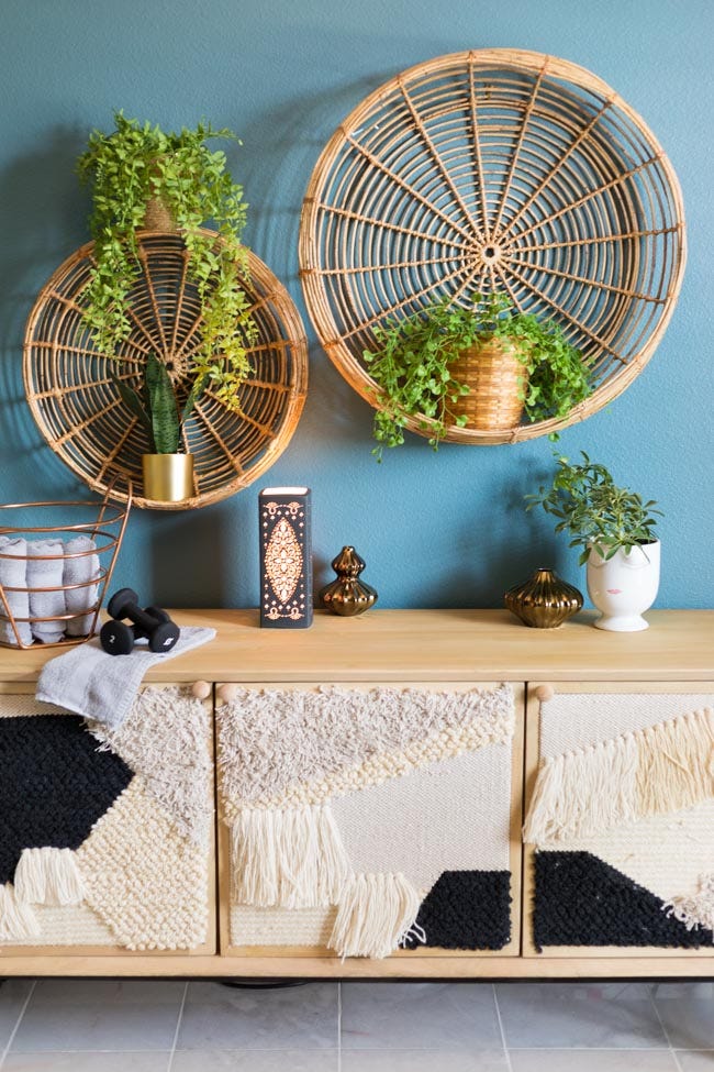 decorative wall and furniture arrangement with plants and various objects